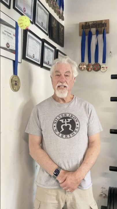 Mike standing before his record wall